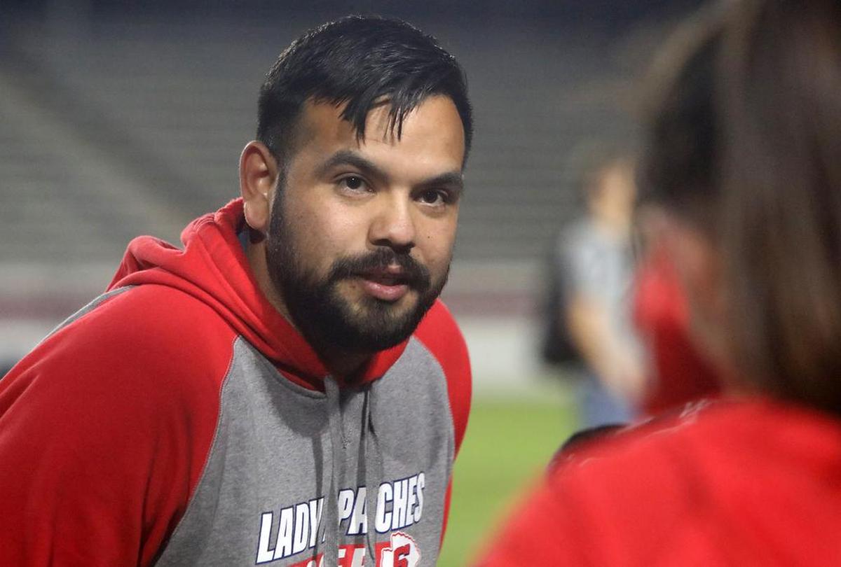 Sanger High girls soccer coach Ángel Cabral talks to the team after its 2-0 CIF Central Section Division II quarterfinal win over St. Joseph's.