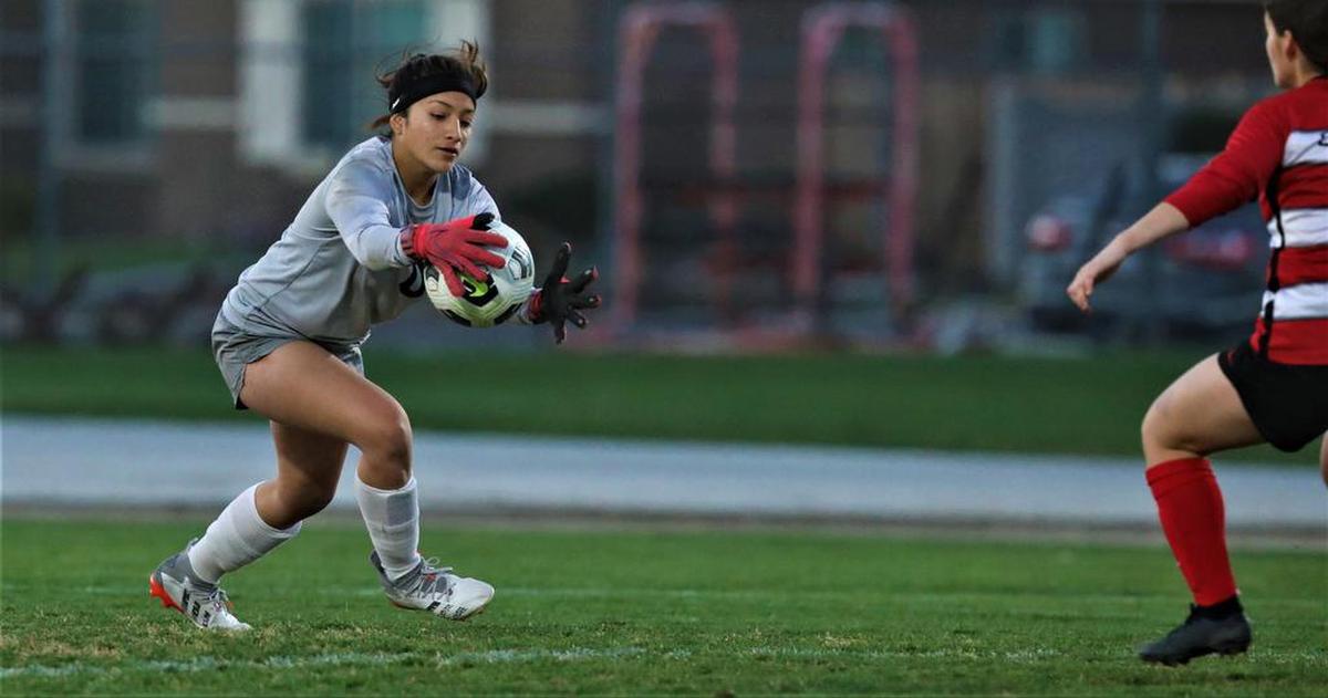 Reedley High goalkeeper Berenice Camacho stops a shot by Kerman.