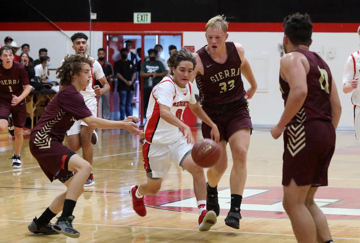 Fowler High senior Alex Aguilar dribbles through a gauntlet of Sierra High defenders during a 59-55 win for the CIF Central Section Division V title.