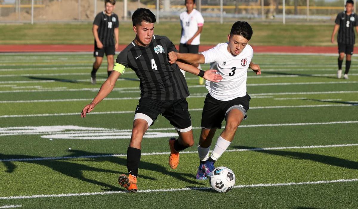 Mendota High midfielder Angel Meléndez and Fowler High midfielder Silvestre Quintero battle for the ball.