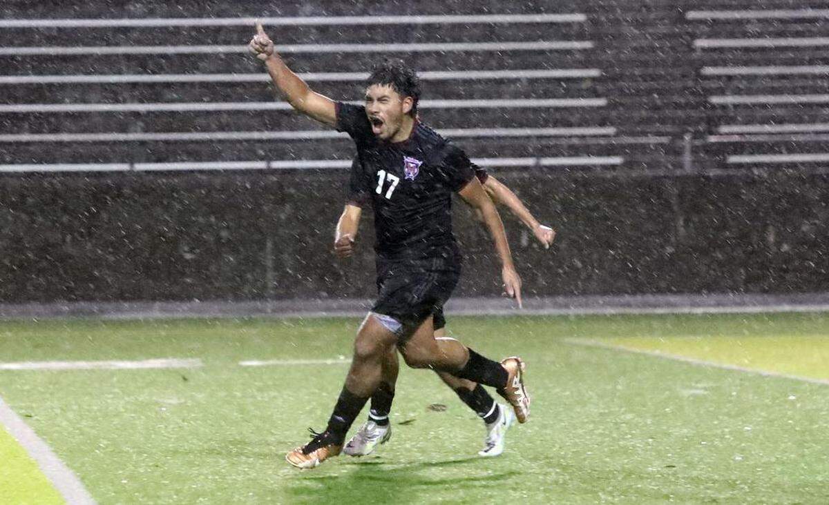 The rain falls as McLane High senior Víctor Luevano celebrates his goal off a free kick to help his team’s 3-2 win in overtime against Chávez High of Delano for the CIF Central Section Division III boys title at home on Feb. 24, 2023.