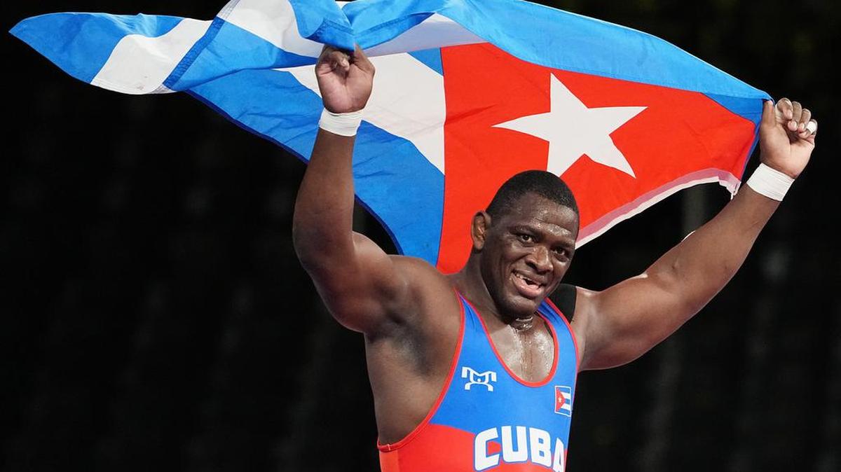 MijaÍn Núñez López of Cuba celebrates after winning against Iakobi Kajaia of Georgia in the men’s Greco-Roman 130kg final match during the wrestling events of the Tokyo 2020 Olympic Games.