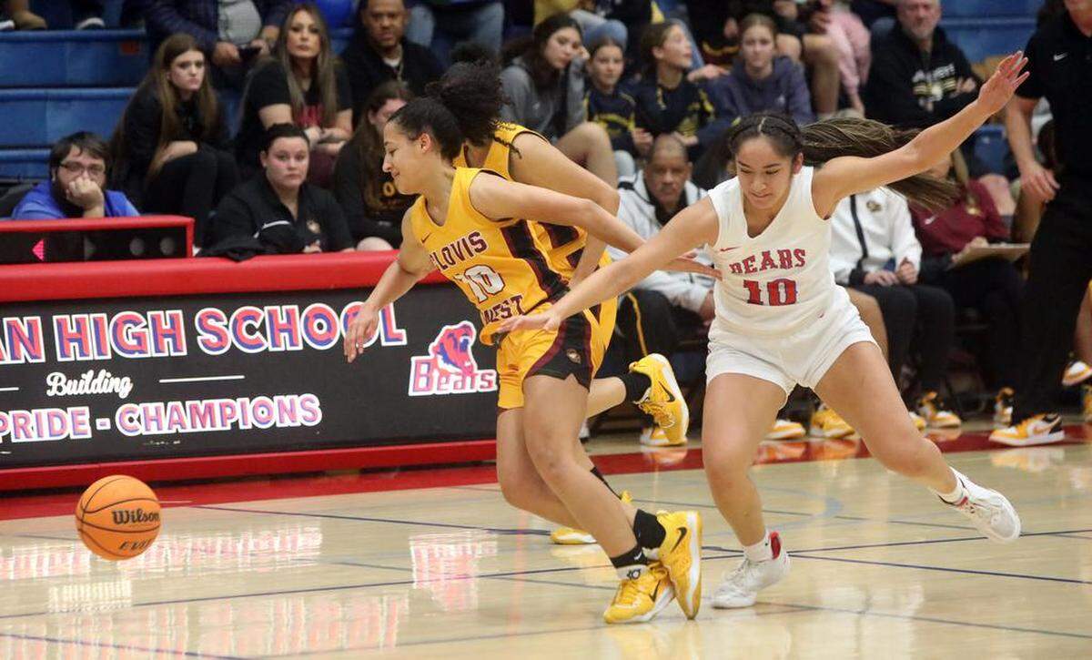 Clovis West senior Trinity Tolbert and Buchanan High senior Kalena Tauiliili tangle in a battle for the ball during a TRAC girls basketball game on Jan. 20, 2023.