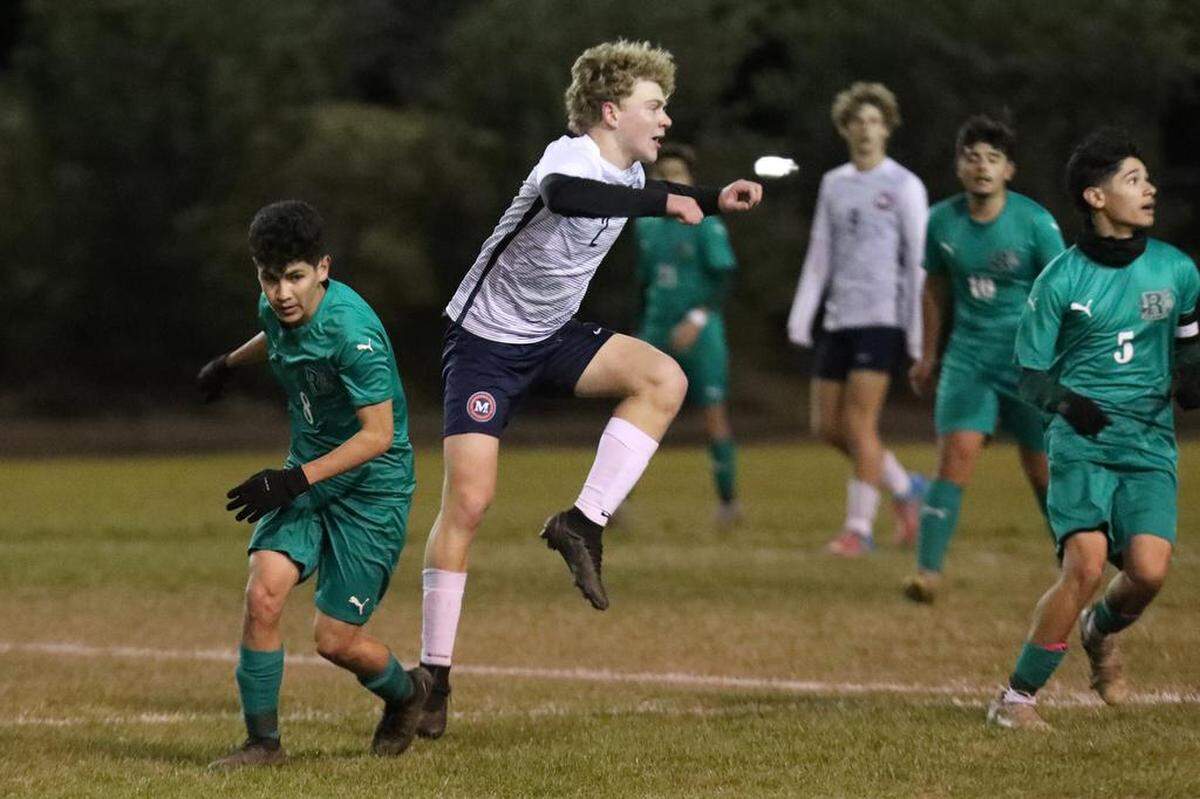 San Joaquín Memorial’s Roman Smith defends against Riverdale High’s Javier Duarte during a CIF Central Section Division IV boys soccer playoff match at Riverdale. The top-seeded Riverdale Cowboys advanced with a 1-0 win to improve to 18-4-4.