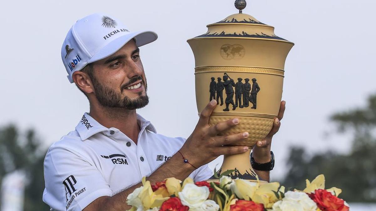 Abraham Ancer of México looks at the trophy after winning the World Golf Championship FedEx-St. Jude Invitational golf tournament at TPC Southwind in Memphis on Aug. 8.