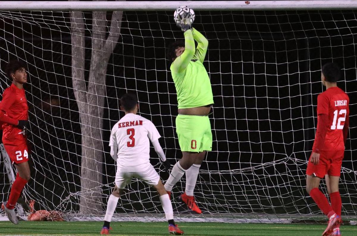 Lindsay High goalkeeper Ángel Nieto stops a shot against Kerman High in a CIF Central Section Division III semifinal.