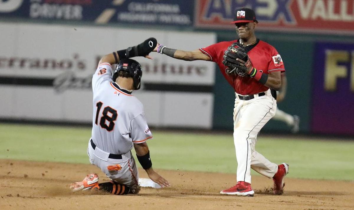 Fresno Grizzlies shortstop Julio Carreras throws to complete a double play against the San Jose Giants.