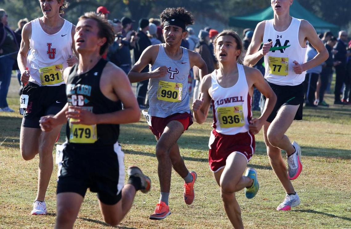 Matilda Torres High (Madera) sophomore Ozzy Hernández runs with a pack of finishers in the boys Division IV race at Woodward Park on Nov. 27, 2021. He clocked 16:42.8 to finish 70th.