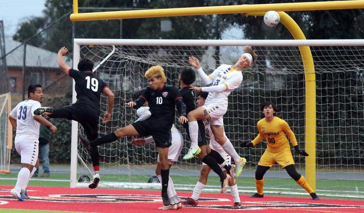 A Terra Linda defenders heads the ball away during the Northern California Division III boys championship match March 4 at McLane High Stadium. Terra Linda won, 2-0.
