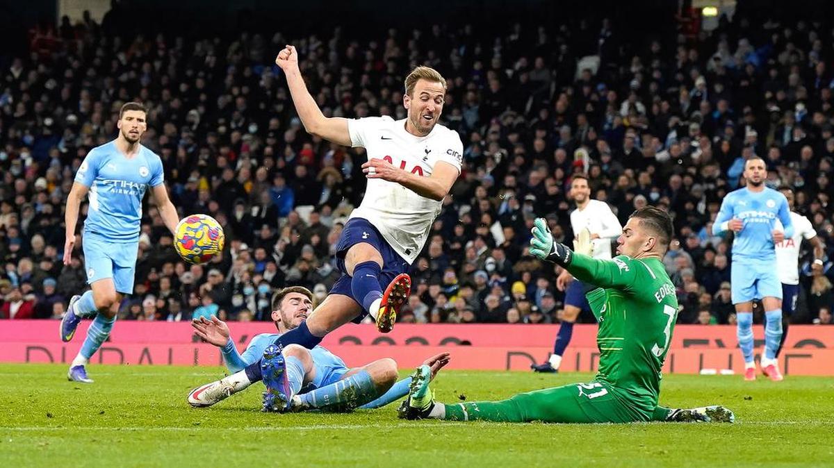 Harry Kane of Tottenham in action against Manchester City's goalkeeper Ederson during the English Premier League soccer match between Manchester City and Tottenham Hotspur in Manchester, Britain.