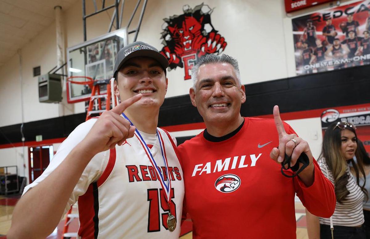 Fowler High senior Lucas Gutiérrez celebrates the 59-55 win over Sierra with his father, Dr. Hank Gutiérrez. The son finished what his father failed to do in 1988: Win the section title game for Fowler.