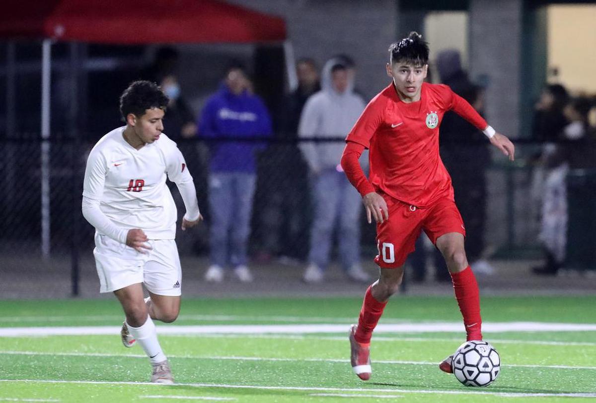 Lindsay High forward Chris Macías looks to pass the ball in the first half of a CIF Central Section Division III semifinal match against Kerman High on Feb. 23, 2022.