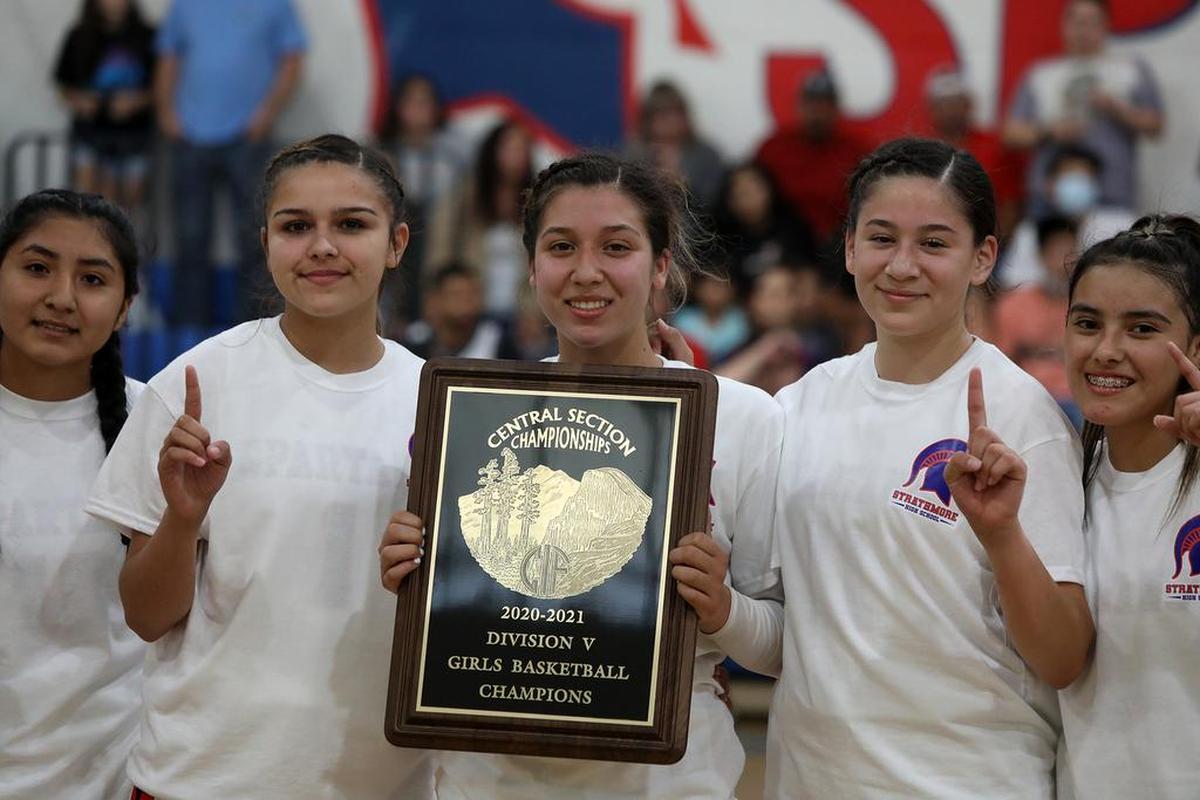 Senior guard Jazmine Soto holds the CIF Central Section Division V basketball championship trophy following a 73-60 win over Corcoran on June 10, 2021.