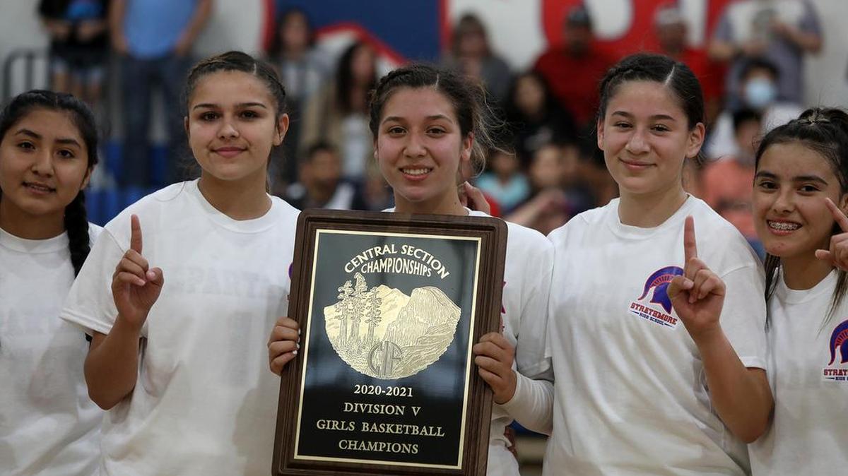 Senior guard Jazmine Soto holds the CIF Central Section Division V basketball championship trophy following a 73-60 win over Corcoran on June 10, 2021.