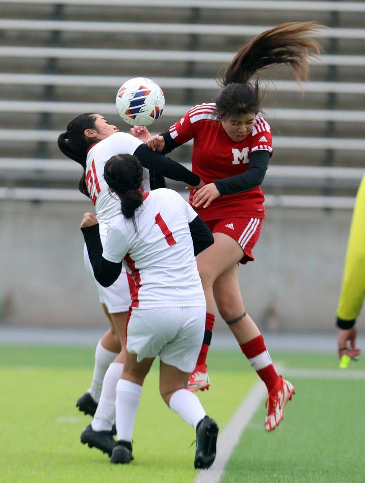 A McLane High player goes high for a header against Rosamond High in the CIF Central Section Division VI championship in rain and wind at McLane High Stadium on Feb. 28, 2023. McLane won, 3-0.