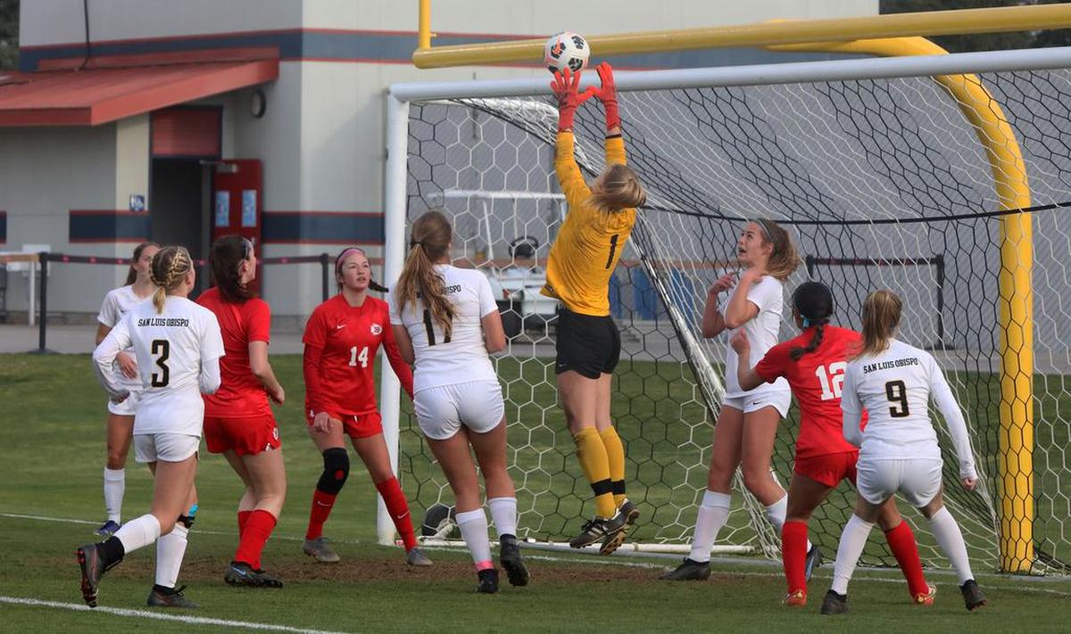San Luis Obispo goalkeeper Riley Wilkerson leaps high to stop a corner kick attempt by Sanger High during the CIF Central Section Division II championship match. Wilkerson will play at Cal Poly SLO.