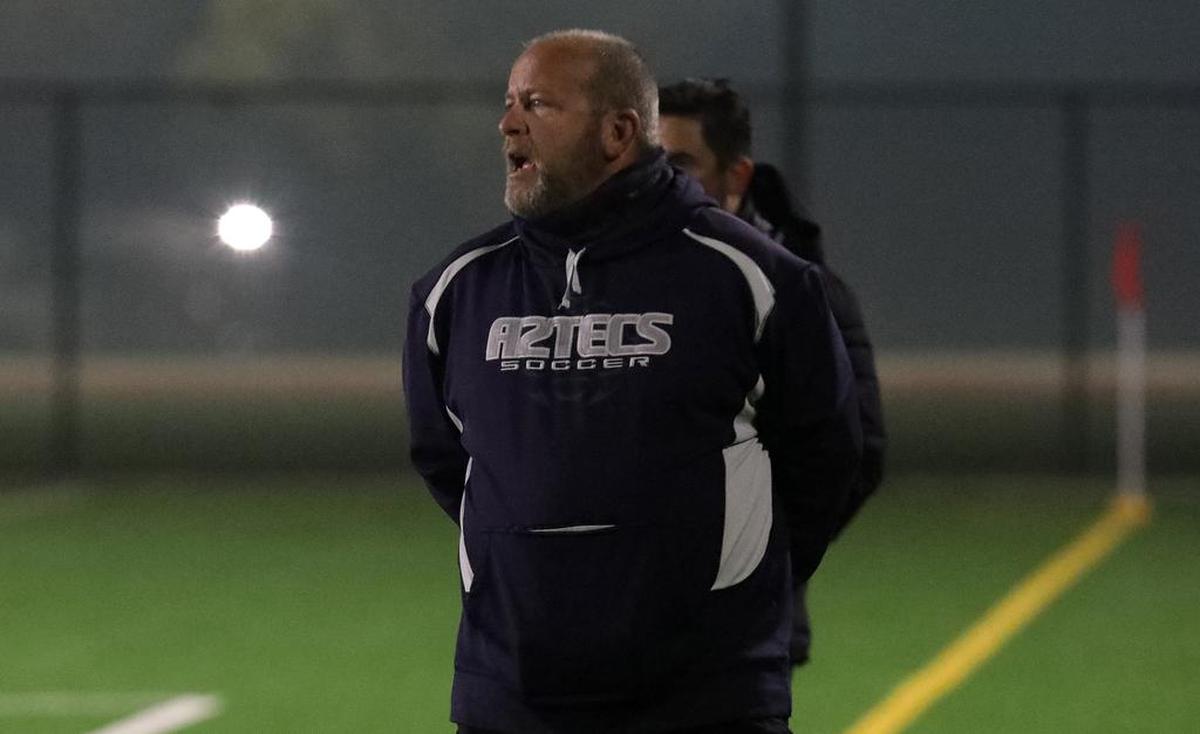 Farmersville High boys soccer coach Michael Jordan roams the sidelines during first-half play against Lindsay High.