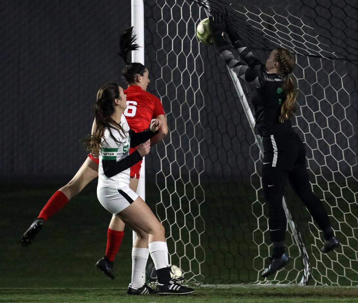 St. Joseph's goalkeeper Brenna Sonsini stops a shot by Sanger High senior Frankie Lee in the first half.