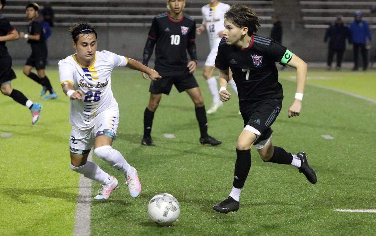 McLane High junior Cristián García tries to drive past Terra Linda defender Elvin Maldonado during the Northern California Division III boys championship match March 4 at McLane High Stadium. Terra Linda won, 2-0.