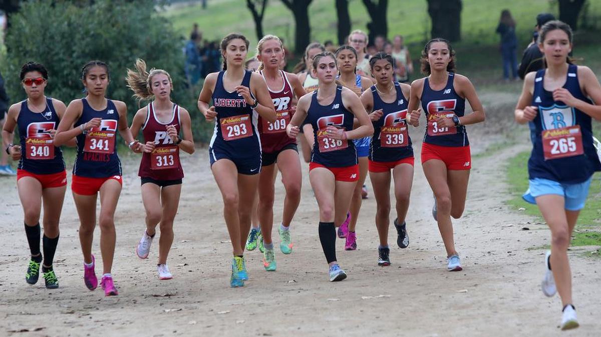 Five Sanger High runners are in the lead pack of the CIF Central Section girls Div. II race near the 1-mile mark. The Apaches dominated the race to capture the team championship.