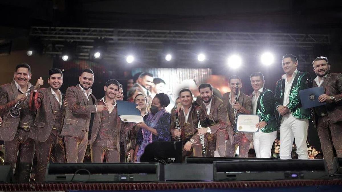 Fotografía personal cedida donde aparecen los integrantes de la Banda El Recodo de Don Cruz Lizárraga mientras posan junto a la congresista Sheila Jackson Lee después de recibir un reconocimiento en nombre de los constituyentes del décimo octavo distrito de Texas durante la presentación de la banda este domingo en la Monumental Plaza Garibaldi, en Houston.