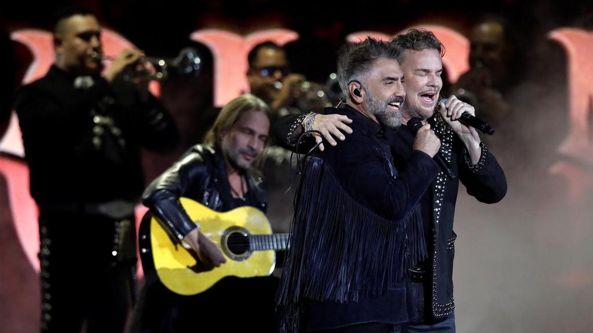 Alejandro Fernández and Fher Olvera of Maná perform during the 22nd annual Latin Grammy Awards ceremony at the MGM Grand Garden Arena in Las Vegas.