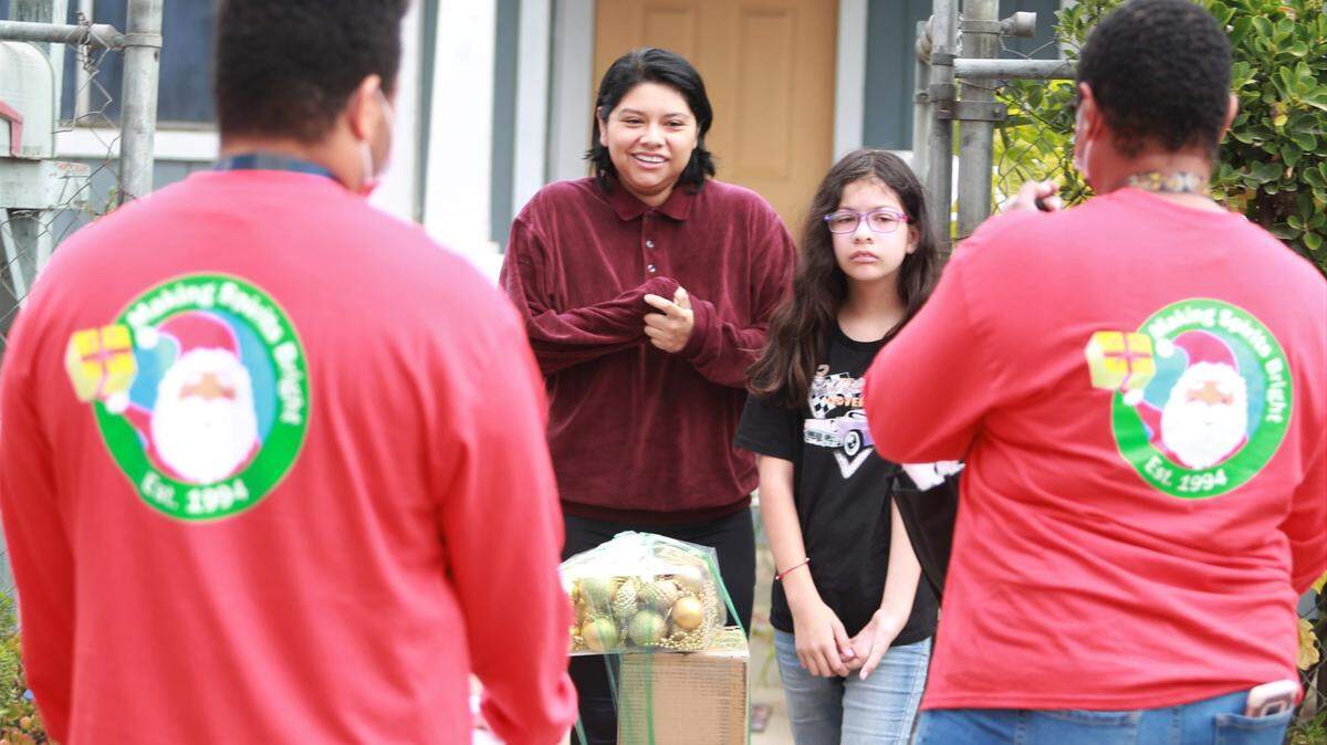 Staff from the Fresno Economic Opportunities Commission Sanctuary and Support Services delivered holiday cheer at the doorstep of Monica Equihua’s home, one of the 25 low-income families selected from Columbia Elementary just west of downtown Fresno for this year’s Making Spirits Bright operation on Saturday morning.