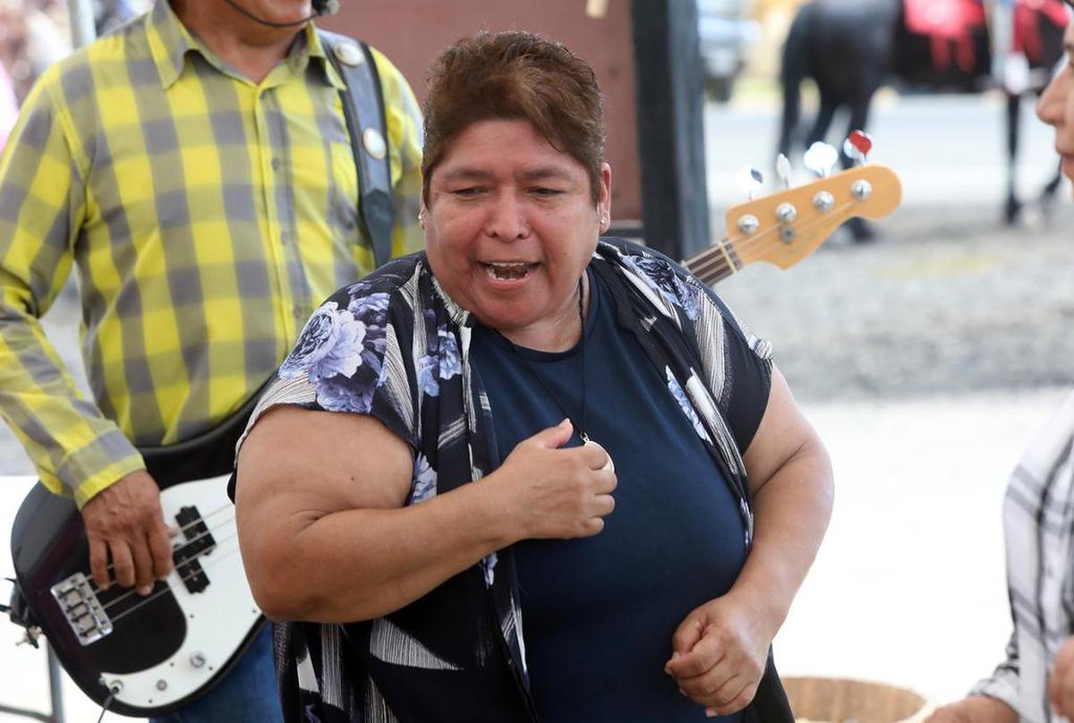 Half-Way Store owner Leticia Fernández dances to a cumbia while Benancio Esparza and his group Galope provides the music during the final day of the Joaquín Murrieta Horse Pilgrimmage on July 31, 2022.