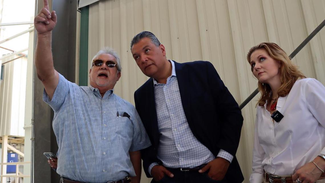 Sen. Alex Padilla listens to Richard Espinoza, plant manager at the Almond Aliance processing facility, during an Aug. 17, 2022 tour of the plant near Cantúa Creek. Almond Alliance president/CEO Aubrey Bettencourt listens.