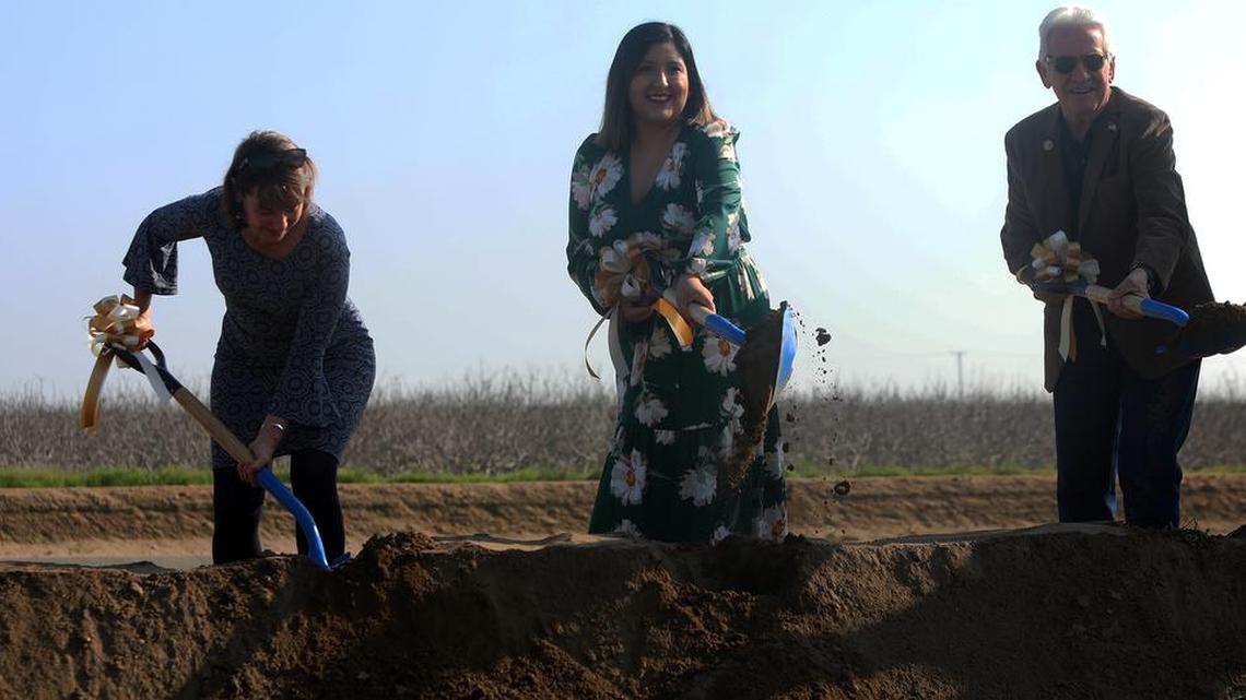 Tanya Trujillo of the U.S. Department of the Interior joins state Sen. Melissa Hurtado and Rep. Jim Costa in the ceremonial shoveling of dirt to mark the start of repair work on the Friant-Kern Canal.