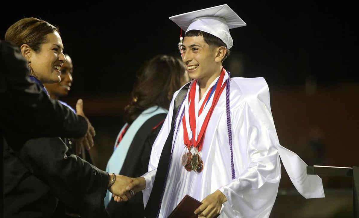 McLane High School valedictorian Isaiah Martínez gets his diploma during graduation ceremony on June 7, 2022.