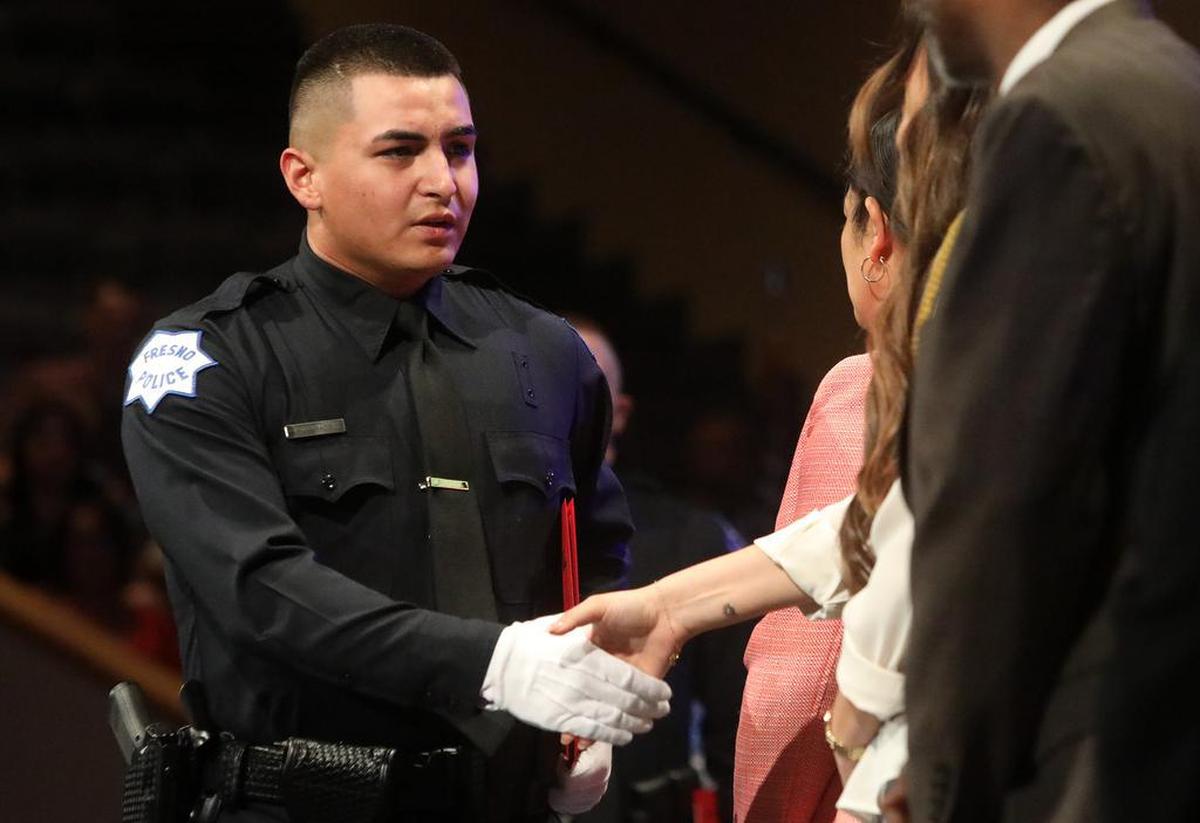 Kameron Jurado, who joins the Fresno Police Department, is congratulated at the State Center Community College Police Academy completion ceremony at CrossCity Church.