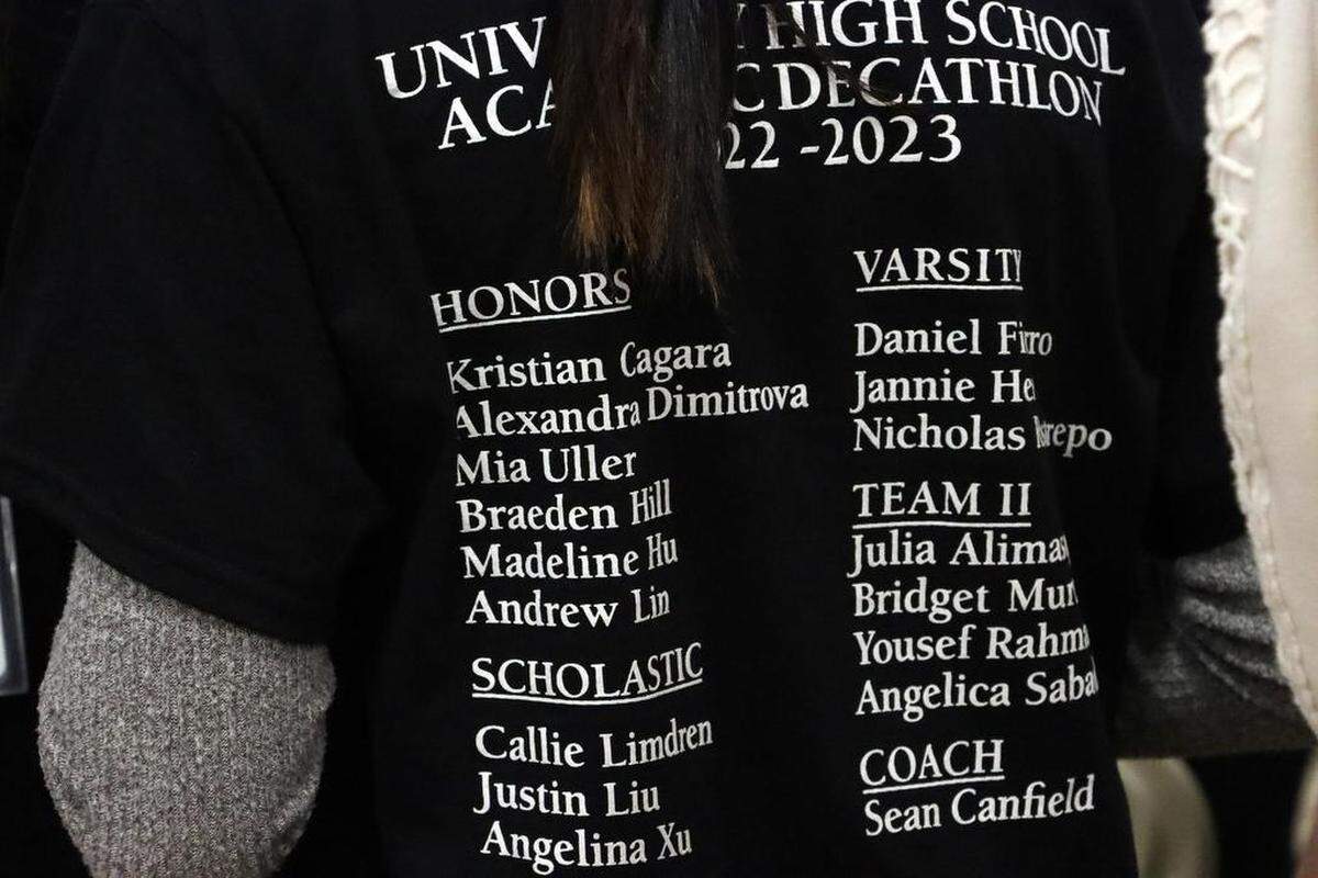 A University High student wears a shirt promoting the 2023 Academic Decathlon team members.