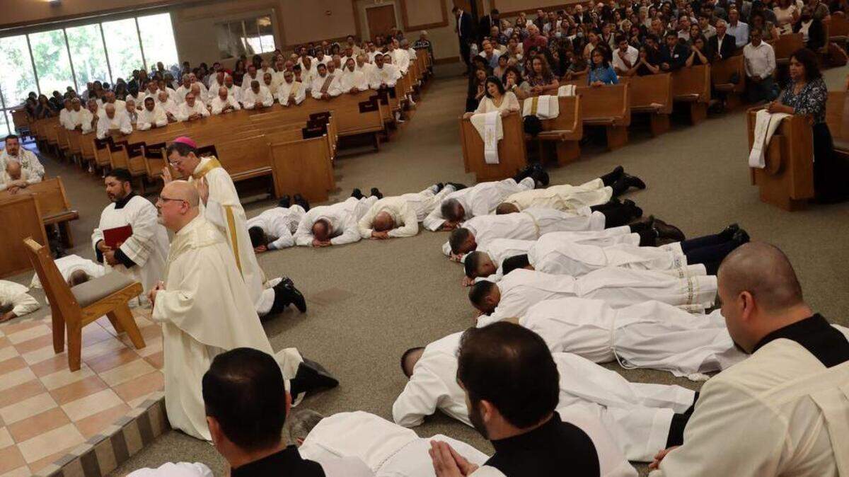 The new deacons kneel spread on the floor during the Mass of Ordination to the Order of Deacon at Hol Spirit Catholic Church in Fresno on Oct. 1, 2022.