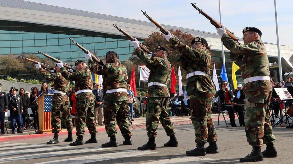 The VFW Post 8900 honor guard handles the gun salute to kick off the Fresno Veterans Day Parade in downtown Fresno on Nov. 11, 2022.