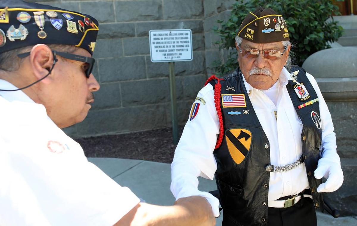 U.S. Army veteran Henry González, 76, greets another veteran during the May 31, 2021 Memorial Day ceremony at Madera Courthouse Park.