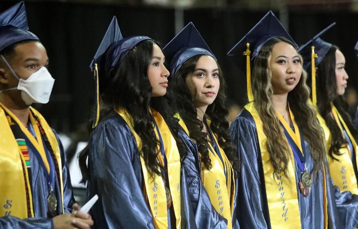 Some of the 69 valedictorians at Sunnyside High School wait to walk to their seats at the Save Mart Center during the June 7, 2022 graduation ceremony.