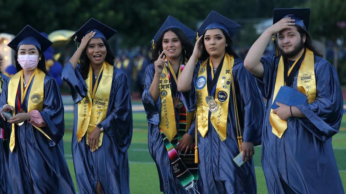 Some of the 61 valedictorians from Sunnyside High School wait during the June 7, 2021 graduation ceremony at the school stadium.