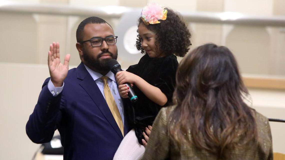Nelson Esparza is sworn in to his second term on the Fresno City Council while his daughter holds the microphone at City Hall on Jan. 5, 2023.