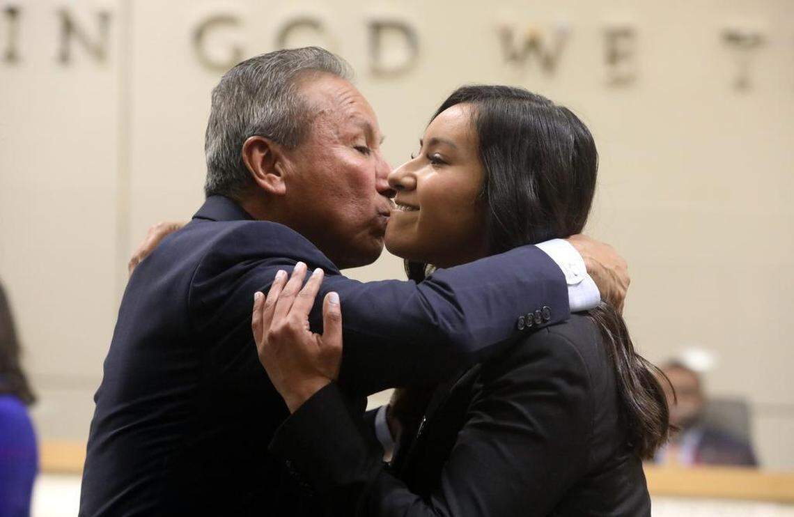 Fresno City Council Vice President Annalisa Perea gets a hug from father Henry R. Perea after being sworn in at City Hall on Jan. 5, 2023.