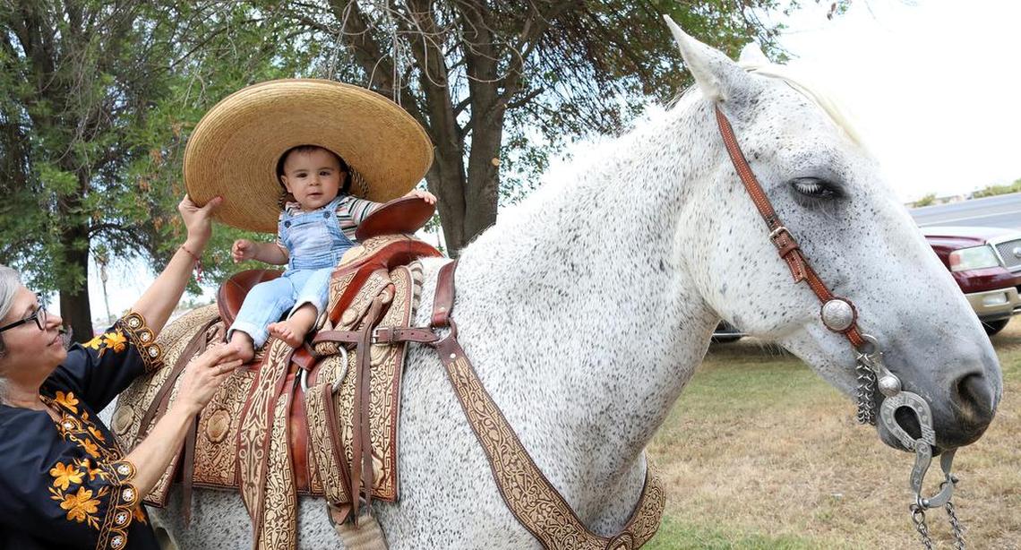 One-year-old Nicco Julián González enjoys sitting on a horse at Lindgren-Lozano Park in Mendota. His great-great-grandfather was one of the four original riders of the Joaquín Murrieta Horse Pilgrimage.