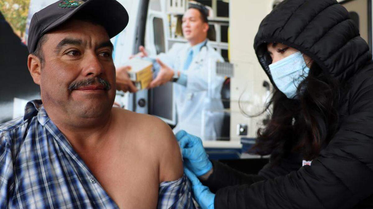 Terranova Ranch worker Ignacio Medina gets a flu shot administered by Lilianna García Pacheco during the Feb. 14, 2023 launch of the Fresno County Rural Mobile Health Program. More than 100 farmworkers participated.