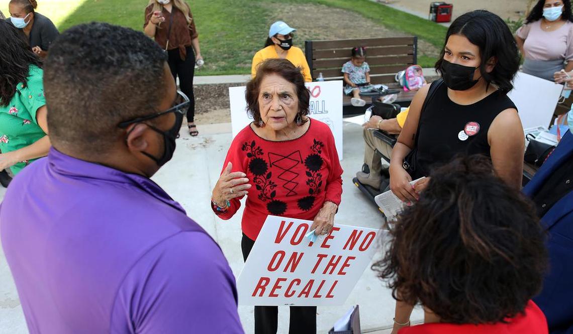 Dolores Huerta habla con el concejal de la ciudad de Kingsburg, Jewel Hurtado (extremo derecho) y otros partidarios después de una manifestación en el centro de Fresno para votar en contra del retiro del gobierno del gobernador Gavin Newsom.