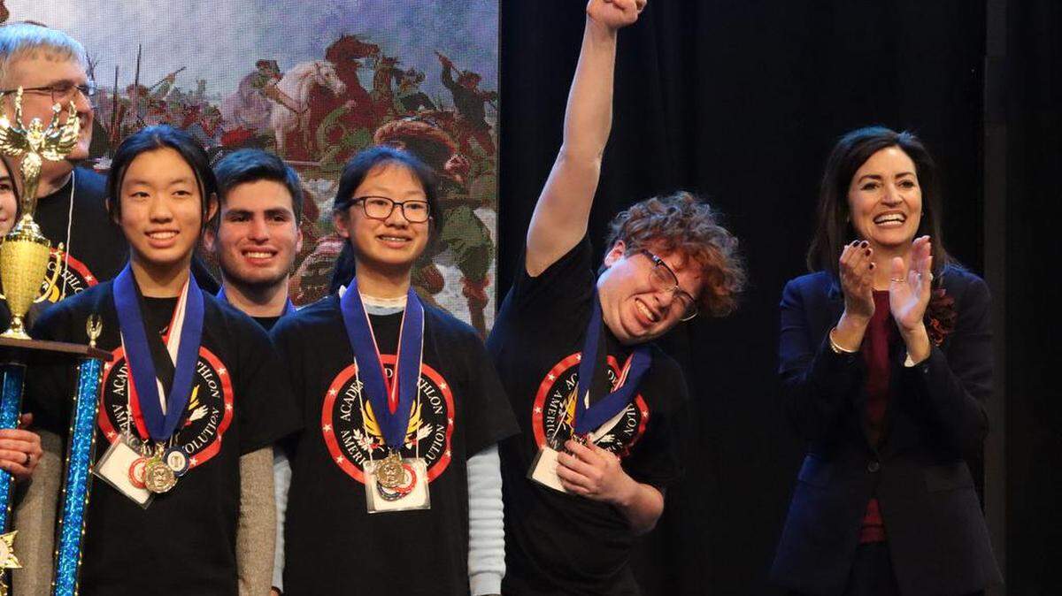 University High student Nicholas Restrepo shows his excitement over his school winning the Fresno County Academic Decathlon for the fourth straight year. On the right is Fresno County Superintendent Michele Cantwell-Copher.