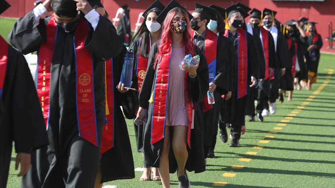Fresno State graduates walk into Bulldog Stadium during the May 16, 2021 morning commencement.