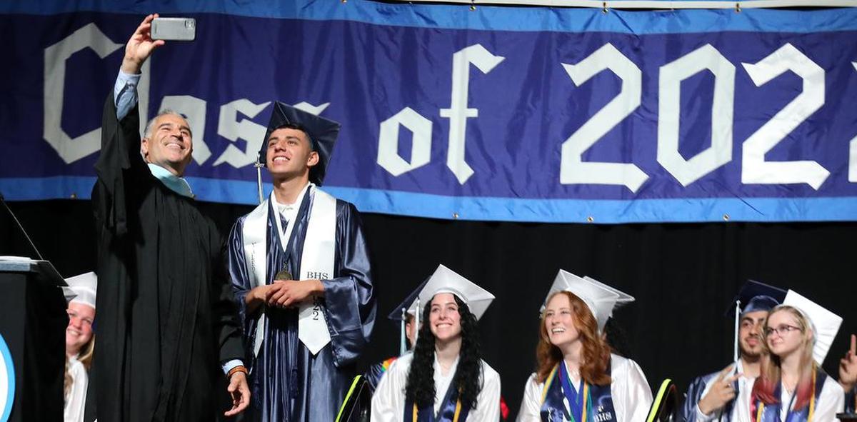 Bullard HIgh School Principal Armen Torigian snaps a selfie with valedictorian Matthew Pulido during the June 8, 2022 graduation ceremony at the Save Mart Center.