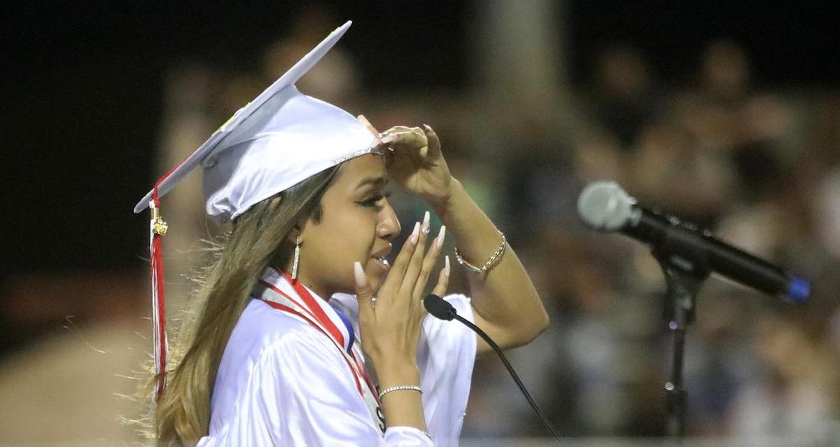 McLane High School valedictorian Concepción Pacheco Cruz wipes tears from her face after congratulating her father for becoming a U.S. resident last month. Pacheco Cruz spoke at McLane's graduation ceremony on June 7, 2022.