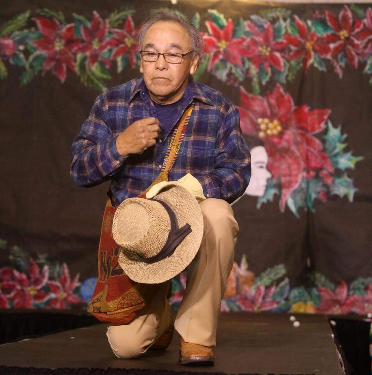 Manuel Aguilar “picks” cotton during the 47th Fiesta Navideña Fashion Show at Fresno Fields on Dec. 4, 2022. The fundraiser was sponsored by the League of Mexican American Women.
