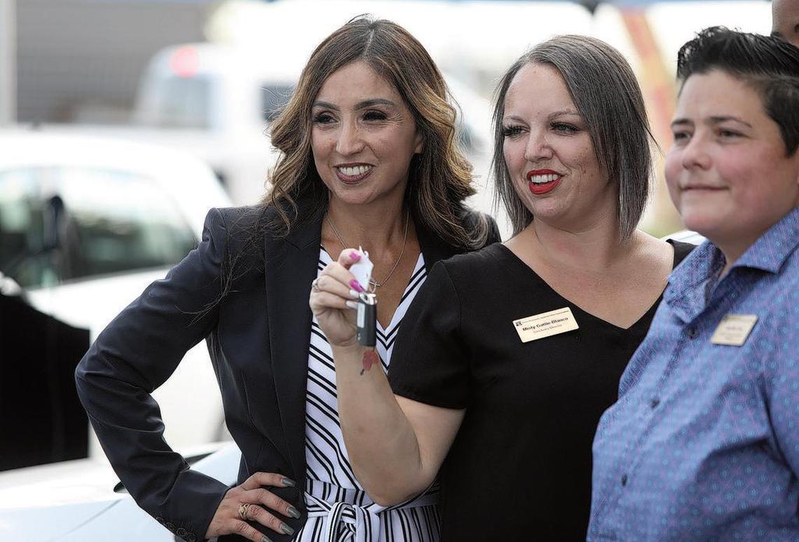Fresno Economic Opportunities Commission executive director Emilia Reyes, left, poses with staff members in accepting donations of electric cars from Electrify America and Valley Clean Air Now on July 16, 2021.