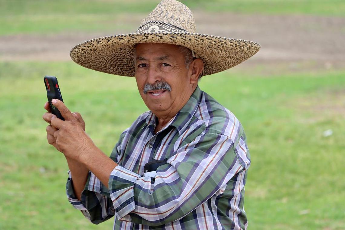 Francisco Romero of Fresno takes photos of the riders and their horses as they arrive at Lindgren-Lozano Park in Mendota on Saturday.